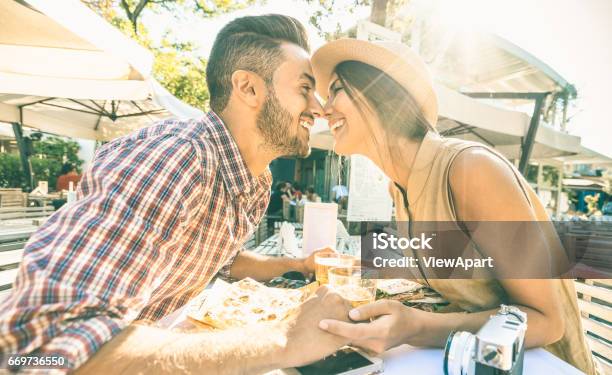 Couple In Love Kissing At Bar Eating Local Delicacie On Travel Excursion Young Happy Tourists Enjoying Moment At Street Food Restaurant Relationship Concept With Lovers At First Date Warm Filter Stock Photo - Download Image Now