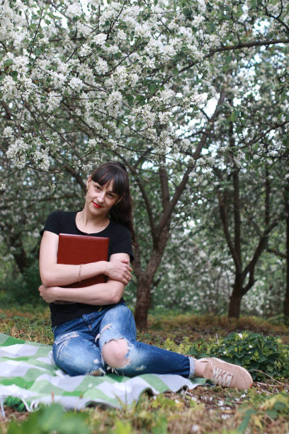 istock girl in a spring apple flower garden 669736684