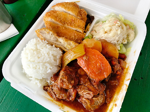 The Hawaiian plate lunch, a local fast food specialty. A variety of combination of local Hawaiian food usually include steam rice, macaroni salad, one or two forms of meat and protein, in this case, a beef stew with carrots and a Katsu fried chicken.