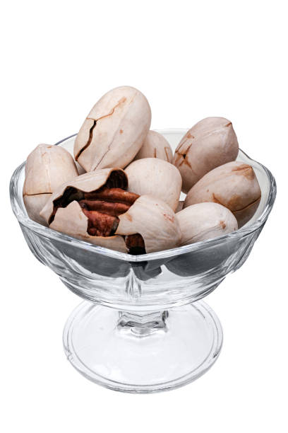 istock Pecan nuts in glass vase isolated on white background 669737878