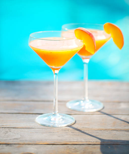 istock Champagne glasses with peach Bellini cocktail 669740848