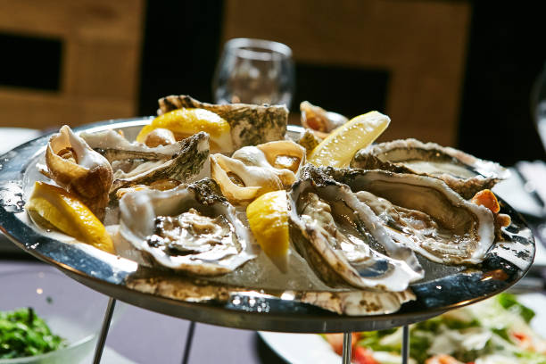 istock platter of fresh organic raw oysters on ice 669744304