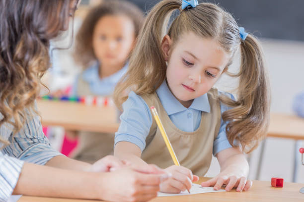 istock Young girl concentrates while at school 669745210