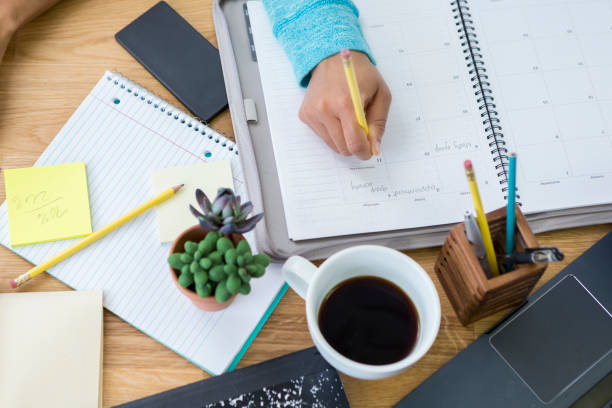 istock Woman writes in personal organizer 669750448