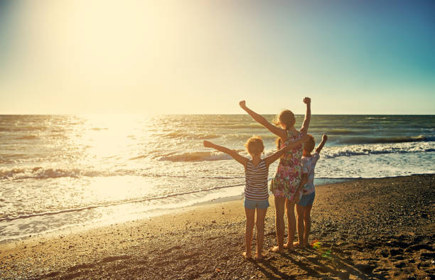 istock Kids enjoying tuscan beach sunset 669750460