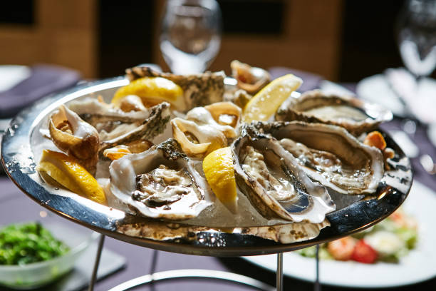 istock platter of fresh organic raw oysters on ice 669751078