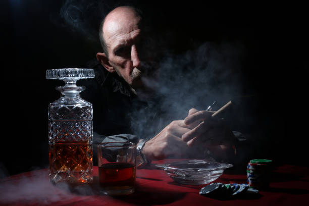 istock man smoke pipe and play poker 669751128