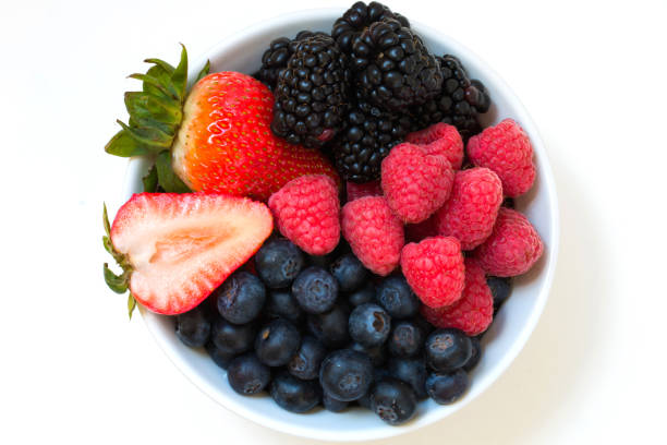 istock Organic fresh mixed berries fruit in a bowl on the table. 669754892