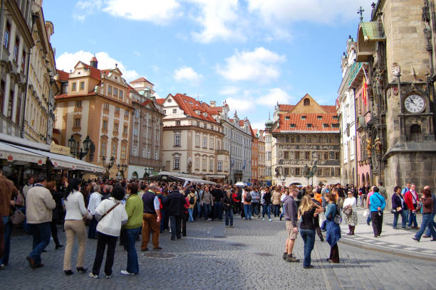 Tourists walking around the old town square in Prague. Some of them are waiting for the astronomical clock performance, that´s why the square is so crowded.