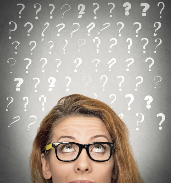 istock beautiful woman with puzzled face expression and question marks above her head looking up 669765380