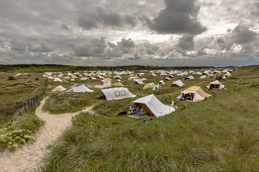 Campsite in the dunes under a clouded sky on the wadden island of Vlieland