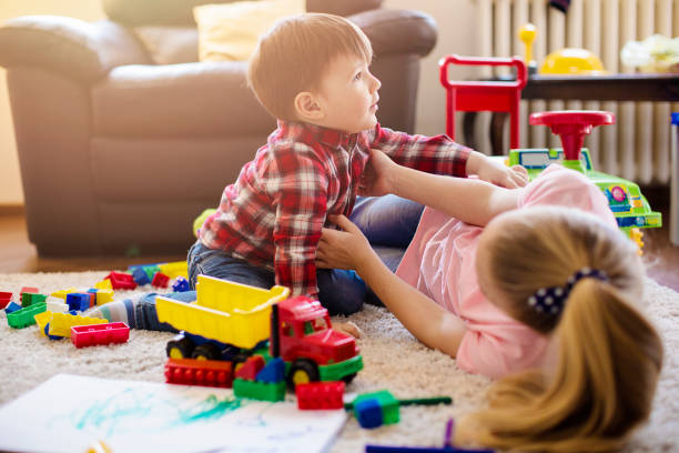 istock Little brother and sister playing together 669775670
