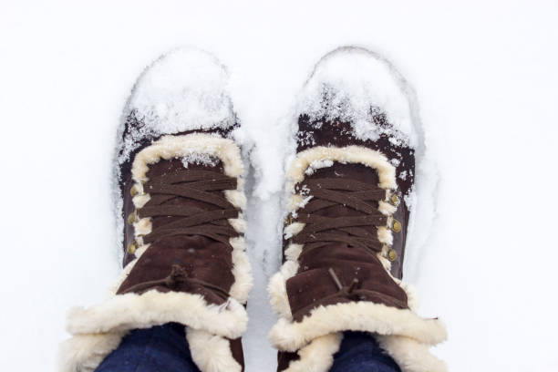 istock Brown fur boots on the snow 669782496