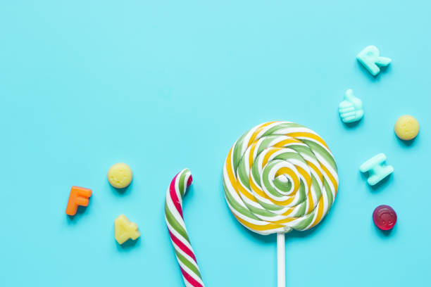 istock lollipop design with sugar candys on blue background top view mockup 669782812