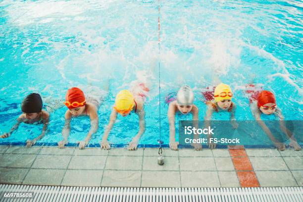 Happy Children Kids Group At Swimming Pool Class Learning To Swim Stock Photo - Download Image Now