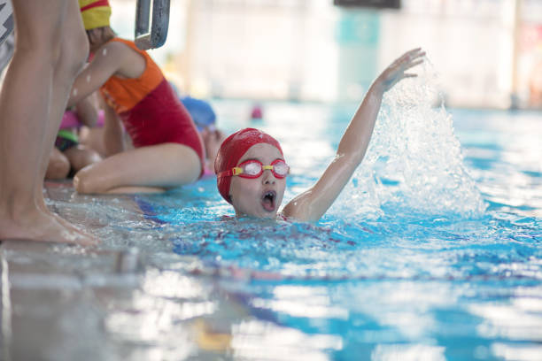 istock happy children kids group at swimming pool class learning to swim 669785676