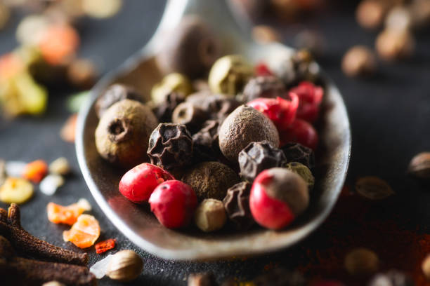 istock Spoon with mixture peppercorns closeup  chalkboard 669792472