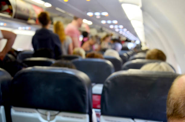seats in the airplane and passenger sitting all area waiting for the plane taking off from runway.