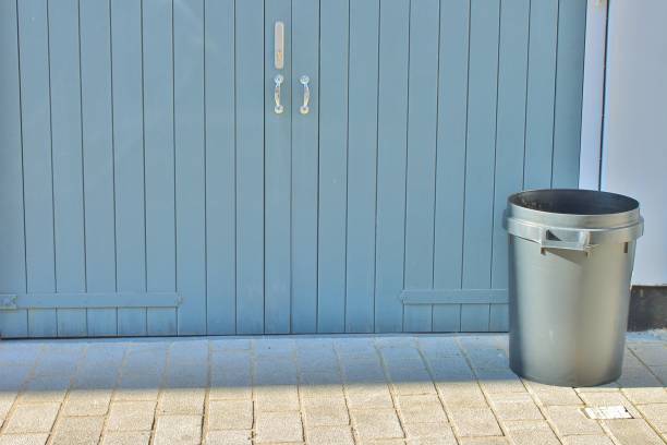 istock Trash can dustbins trashcan rubbish bins outside against brick wall 669801548