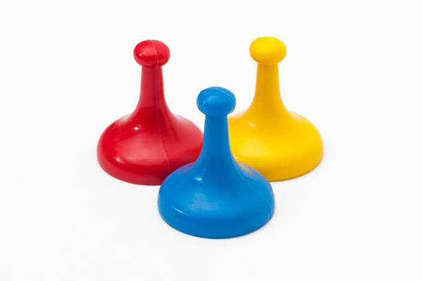 three game tokens in primary colors - board game piece leisure games blue isolated imagens e fotografias de stock