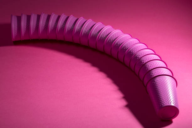 istock Plastic disposable pink cups on a pink background 669821662