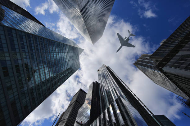 istock Airplane in New York City Between Buildings 669828372