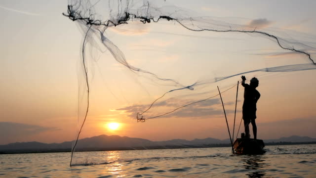 Fisherman on longtail boat fishing