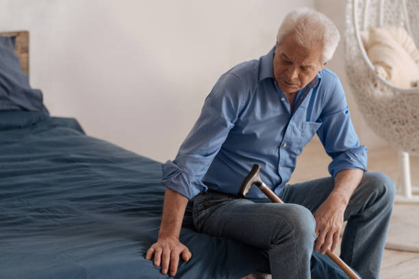 istock Unhappy cheerless man sitting on the bed 669840178