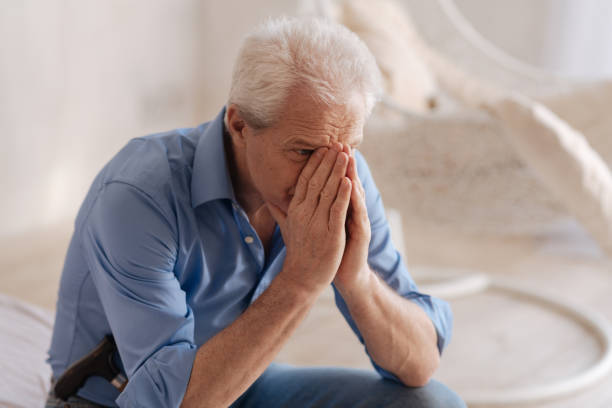 istock Unhappy senior man covering his face 669842258