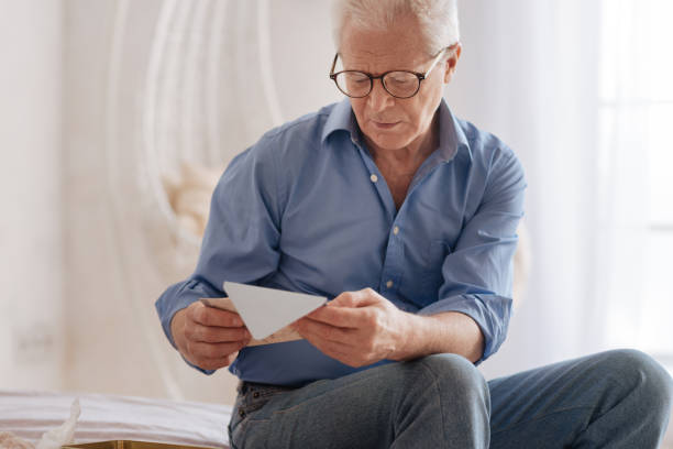 istock Moody cheerless man reading an old letter 669842410