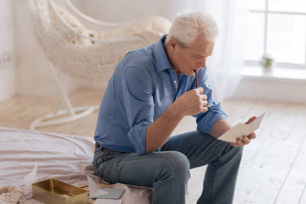 Serious thoughtful man biting his glasses