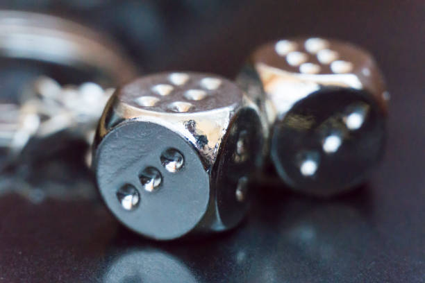 istock Two metal dices on glass background 669844136