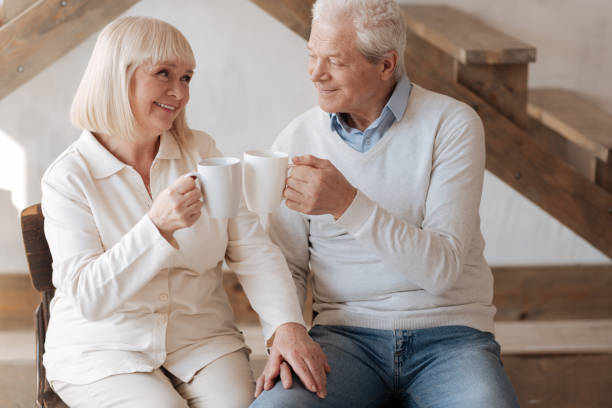 istock Positive delighted couple clinking cups 669846520