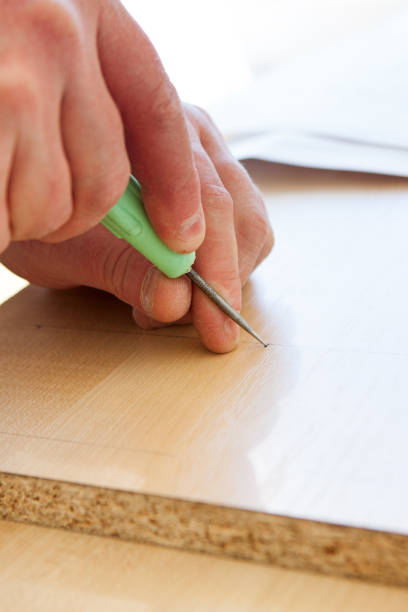 istock man makes a hole with an awl 669846794