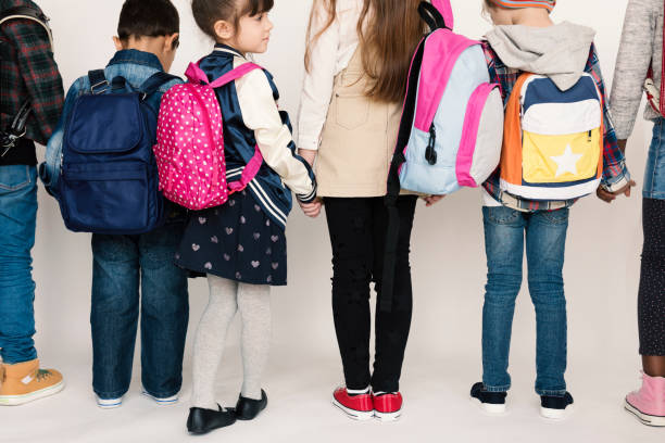 istock Group of Schoolers Kids with Backpack Behind Rear View on White Blackground 669850688