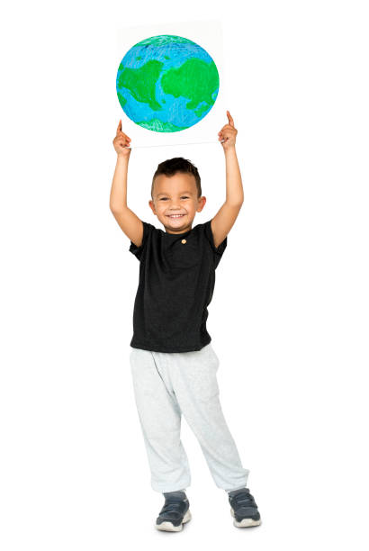 istock Happiness little boy smiling and holding ecology globe placard 669851442