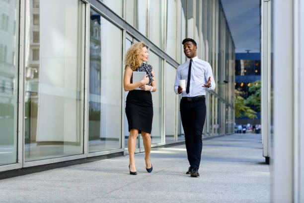 istock Business colleeagues walking along the office building 669853744