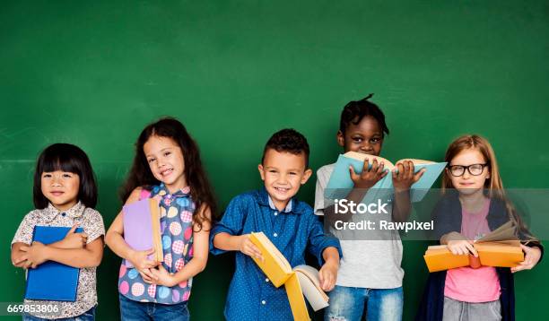 Grupo De Niños De La Escuela De Educación Foto de stock y más banco de imágenes de Niño - Niño, Leer, Libro