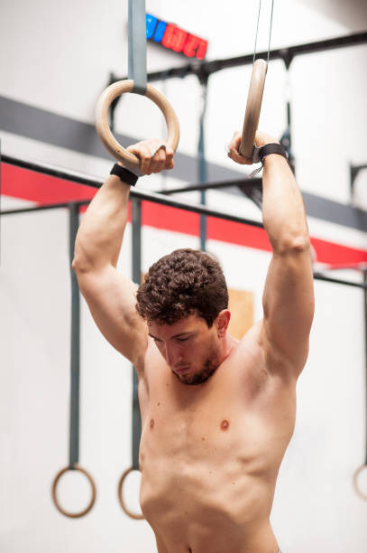 istock Muscular gymnast exercising on rings 669854838