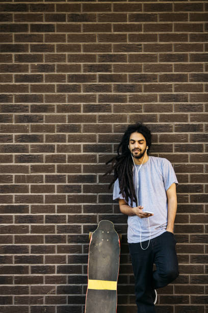 istock Young male with dreadlocks and longboard 669857926
