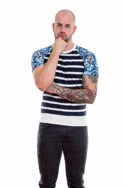 istock Studio shot of young bald muscular man standing while thinking 669858294