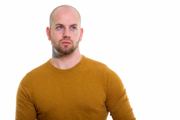 istock Studio shot of young bald muscular man thinking 669858470