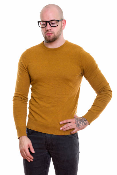 istock Studio shot of young bald muscular man wearing eyeglasses while thinking and looking down 669858624