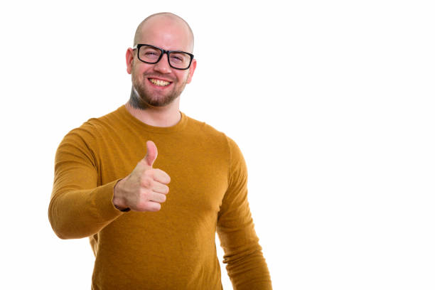 istock Young happy bald muscular man smiling while giving thumb up 669858788