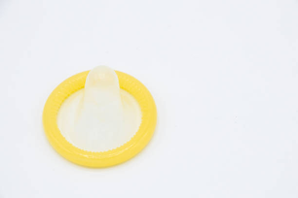 istock Yellow condom isolated on white background 669863196