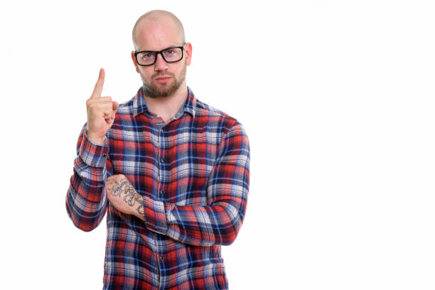 istock Studio shot of young bald muscular man pointing finger up 669865574