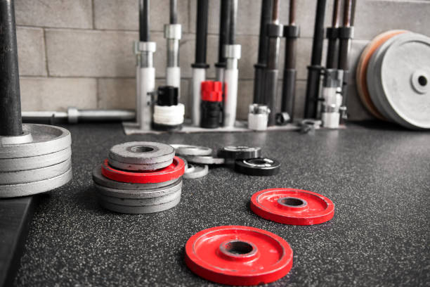 istock Assorted weights scattered on the floor of a gym 669866248