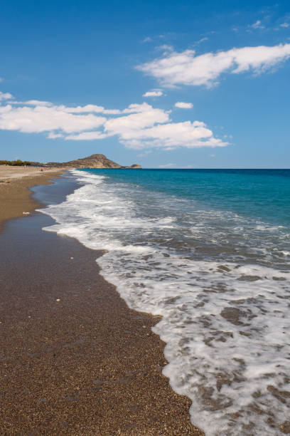 Afandou beach with waves on sunny day, Rhodes Sandy Afandou beach on Rhodes, Greece afandou stock pictures, royalty-free photos & images