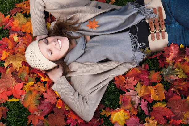 istock Woman sleeping on autumn leaves 669876930