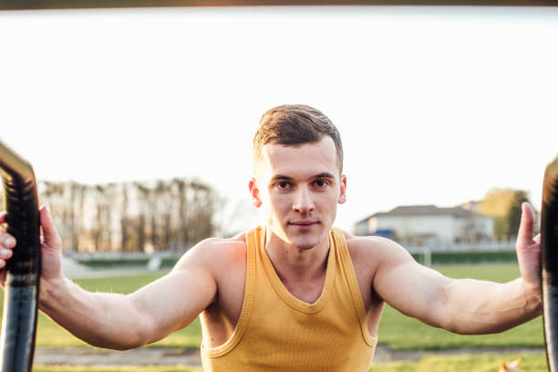 istock Man do workout at stadium area with sunshine background 669883256
